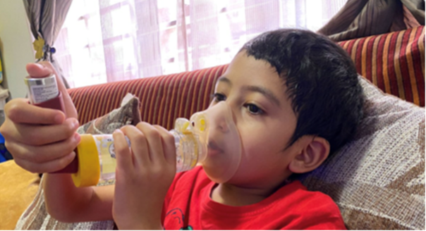 Boy using inhaler EASY asthma.png