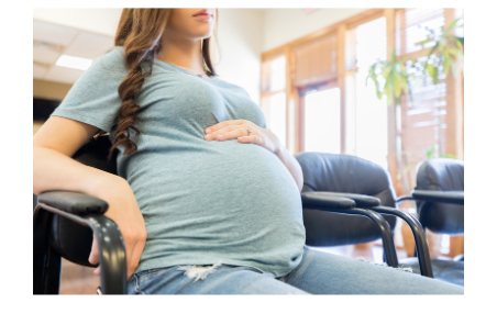 Woman holding baby bump