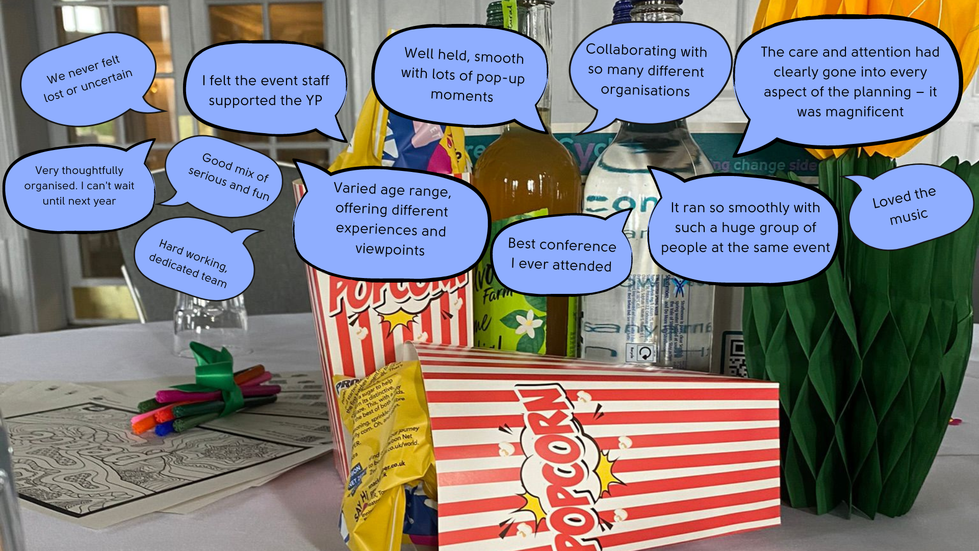 Photograph of popcorn and conference table items annotated with quotes from attendees about the organisation of the event