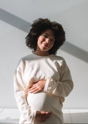 Pregnant woman holding belly